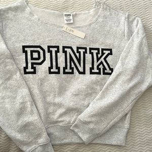 New pink side shoulder sweater. Grey color medium size